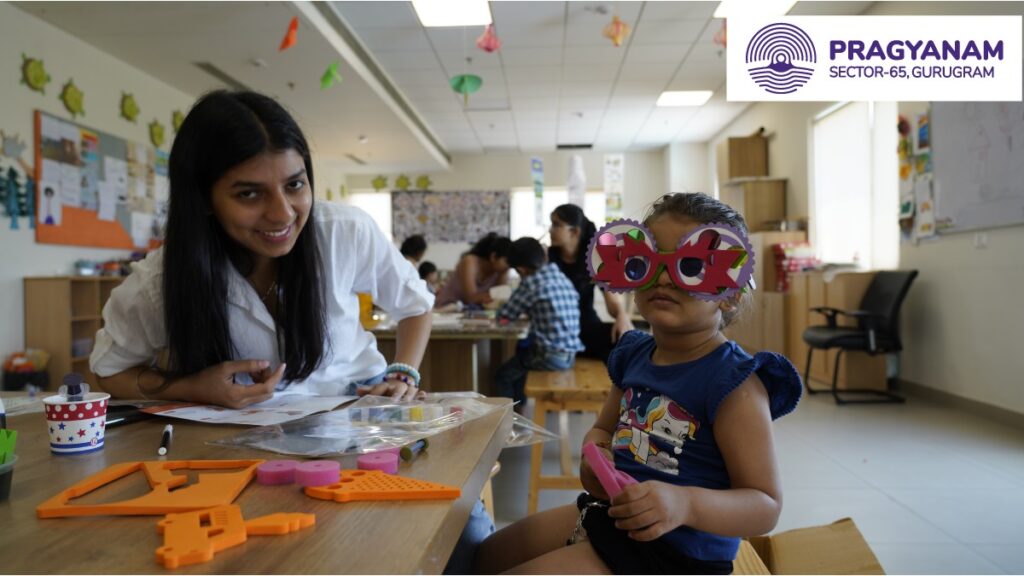 A Teacher Sitting with a Child 